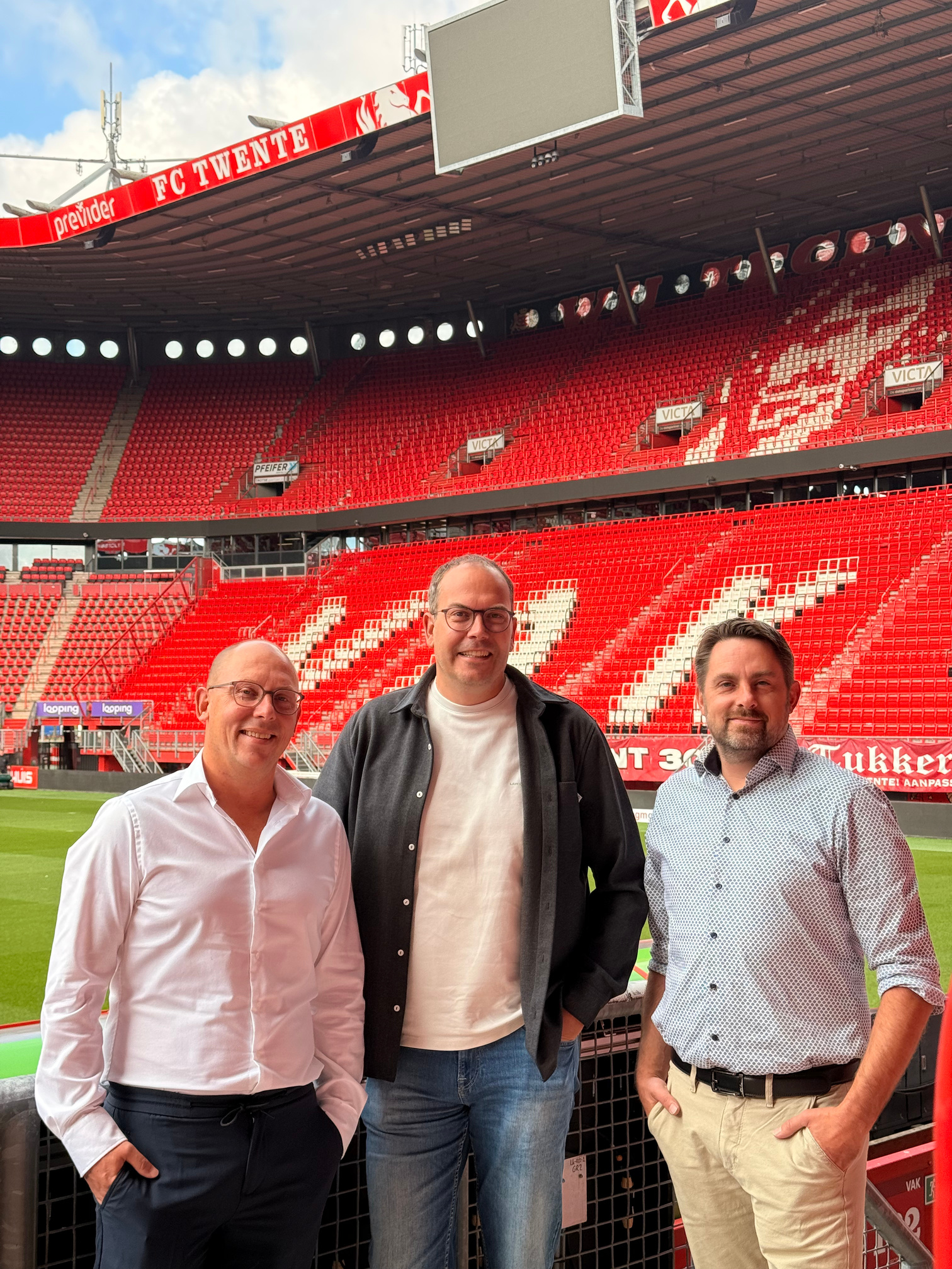 Drie mensen van Business Data Challengers en Artific in het stadion van FC Twente